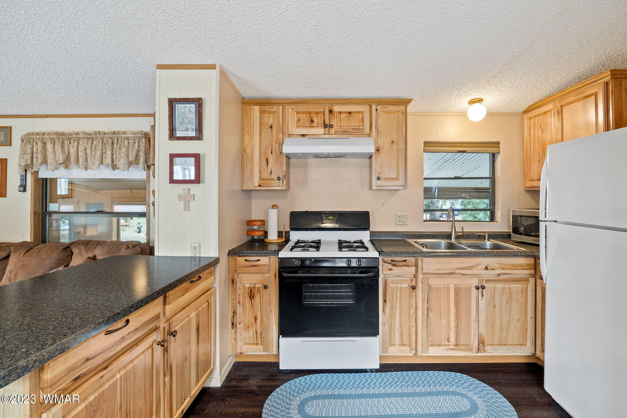 20 County Road 2140 Alpine, AZ 85920 - Photo 6 of 32 a kitchen with stainless steel appliances granite countertop a stove a sink and a refrigerator