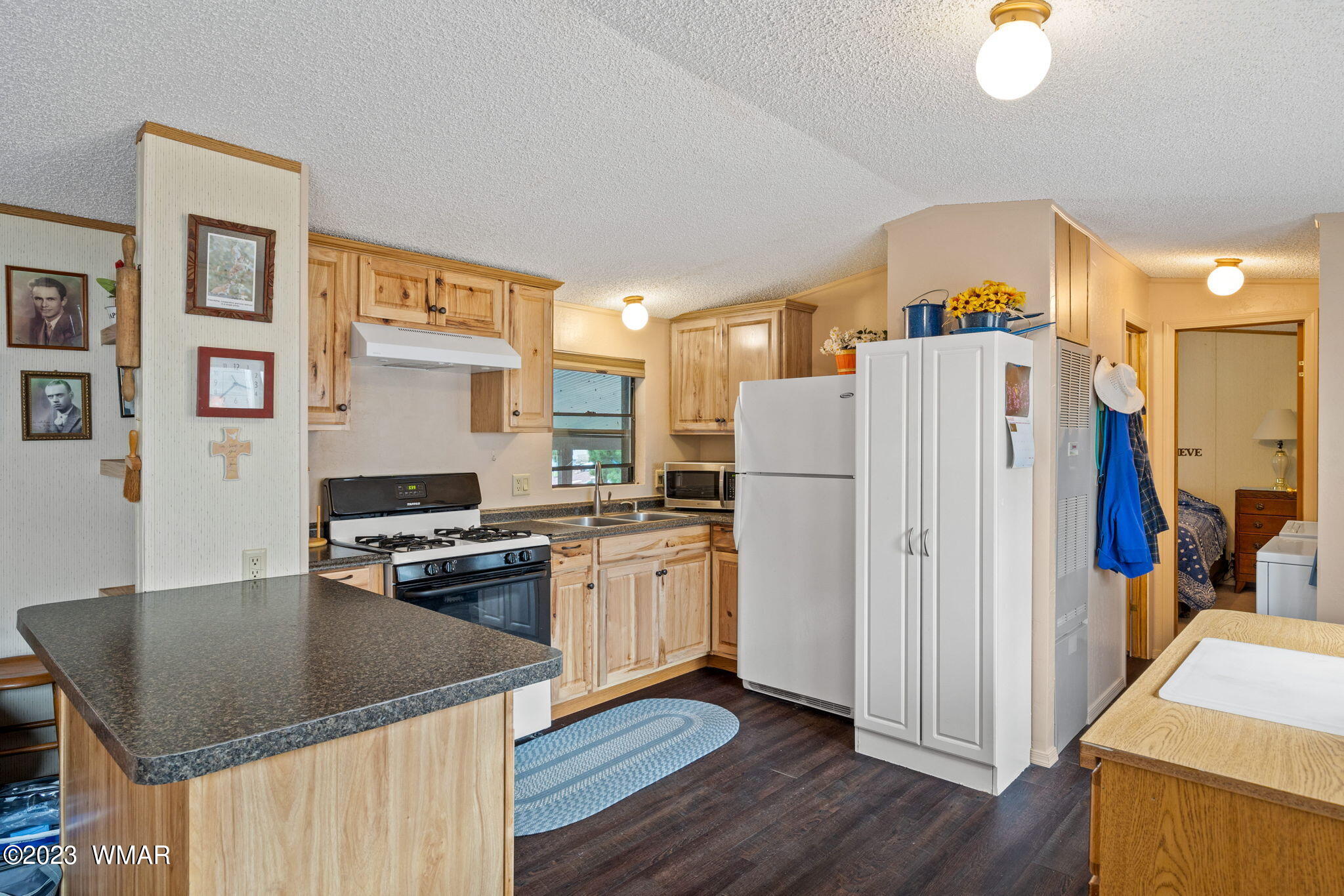 20 County Road 2140 Alpine, AZ 85920 - Photo 7 of 32 a kitchen with stainless steel appliances granite countertop a refrigerator a stove top oven a sink and dishwasher