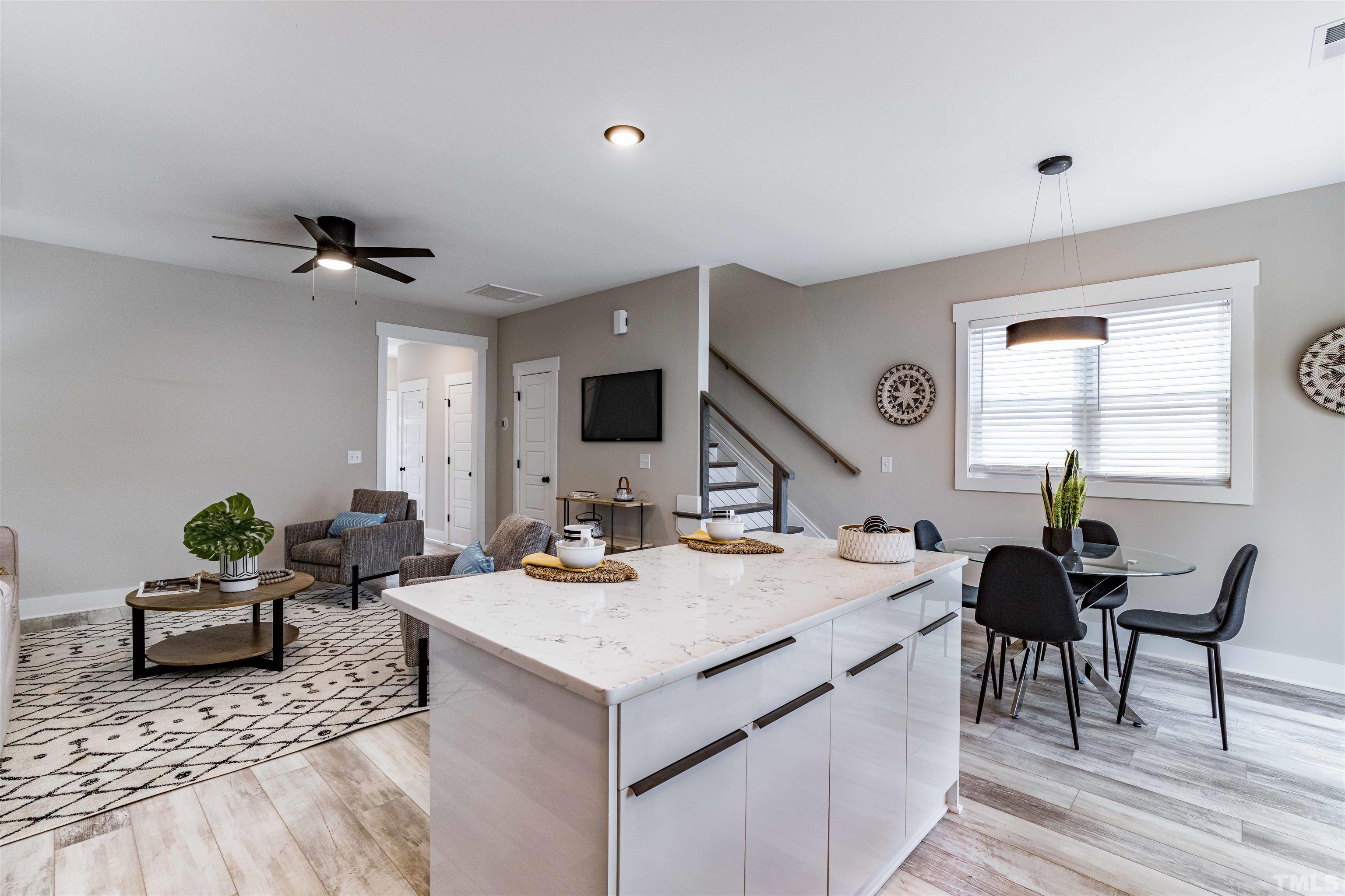 3916 Convergence Street Durham, NC 27704 - Photo 16 of 34 a living room with stainless steel appliances kitchen island granite countertop furniture a rug and a window