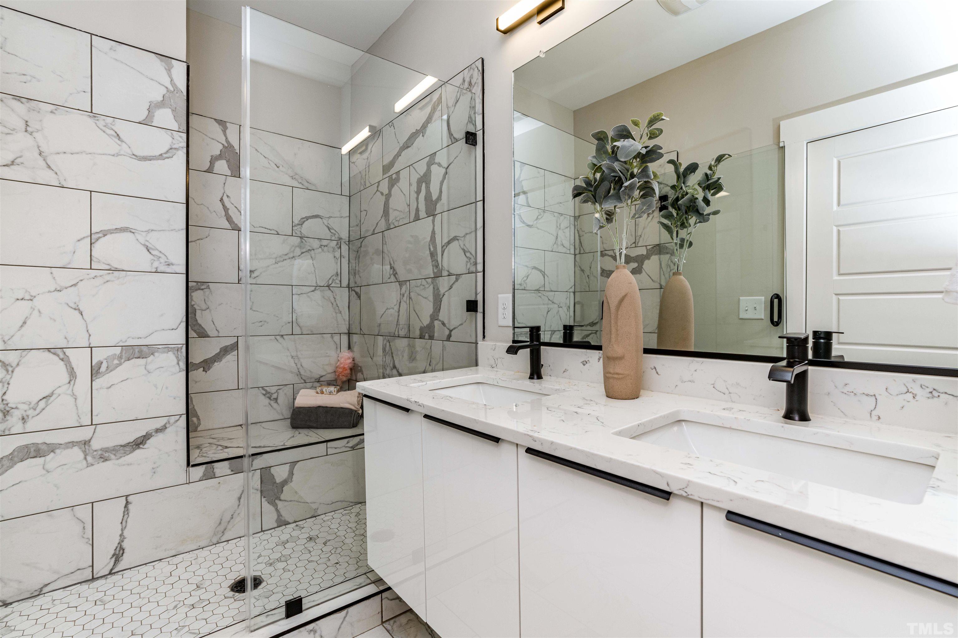 3916 Convergence Street Durham, NC 27704 - Photo 23 of 34 a bathroom with a granite countertop sink a mirror and shower