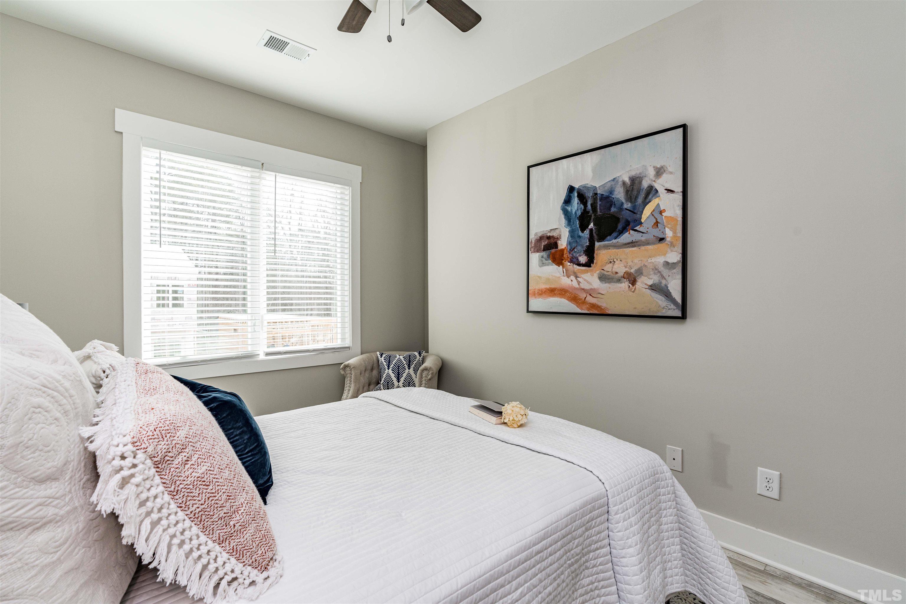 3916 Convergence Street Durham, NC 27704 - Photo 26 of 34 a bedroom with a bed and a painting on the wall
