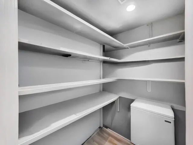 a view of storage and utility room with racks on the wall