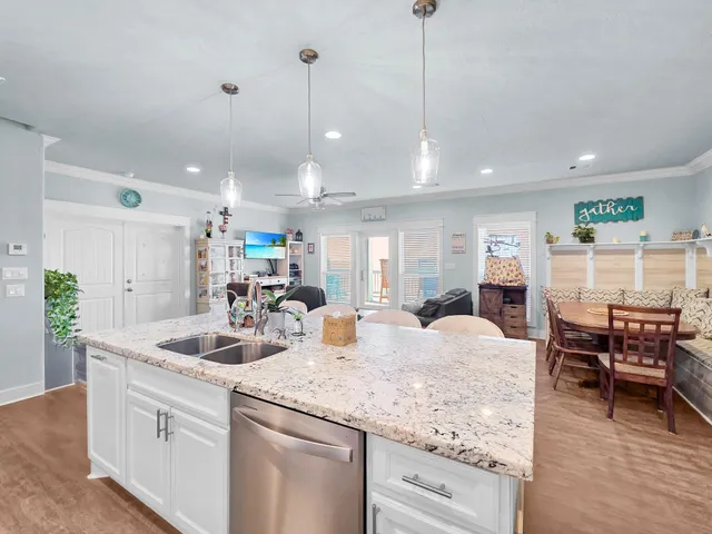 a kitchen with center island table and chairs