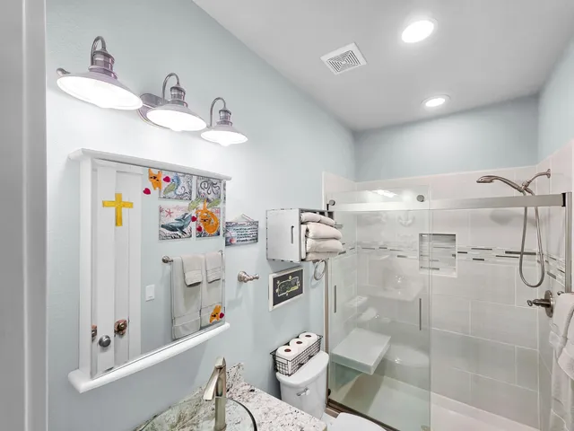 a bedroom with a bed furniture and paintings on the wall