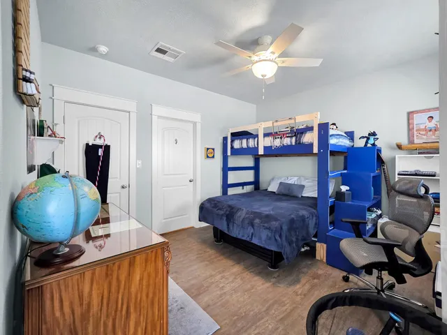 a bedroom with bed and wooden floor