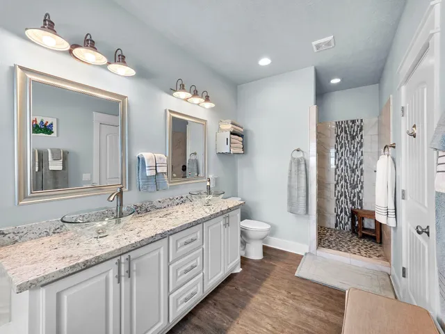 a bathroom with a double vanity sink mirror and bathtub