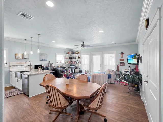 a kitchen with stainless steel appliances kitchen island granite countertop a sink a stove top oven a counter space and cabinets