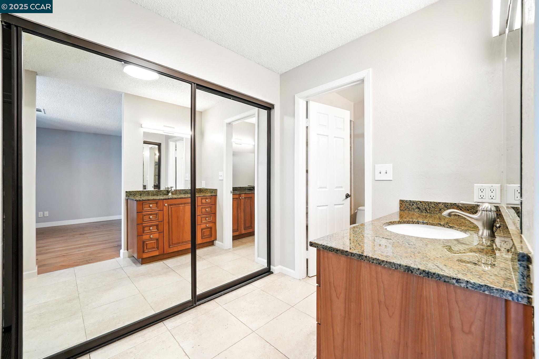 267 Duperu Drive Crockett, CA 94525 - Photo 34 of 50 a bathroom with a granite countertop sink and a mirror