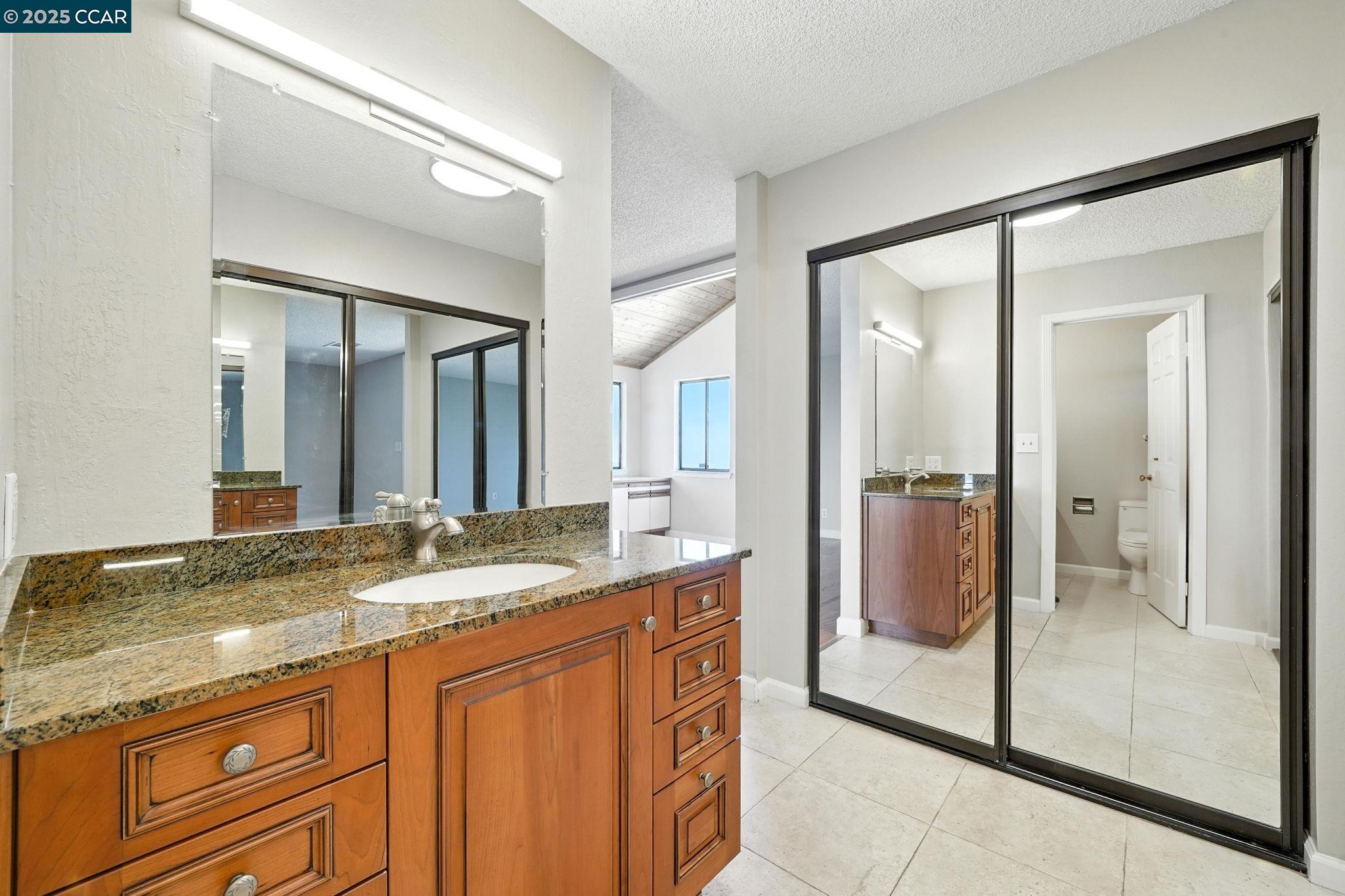 267 Duperu Drive Crockett, CA 94525 - Photo 35 of 50 a bathroom with a granite countertop sink mirror and shower