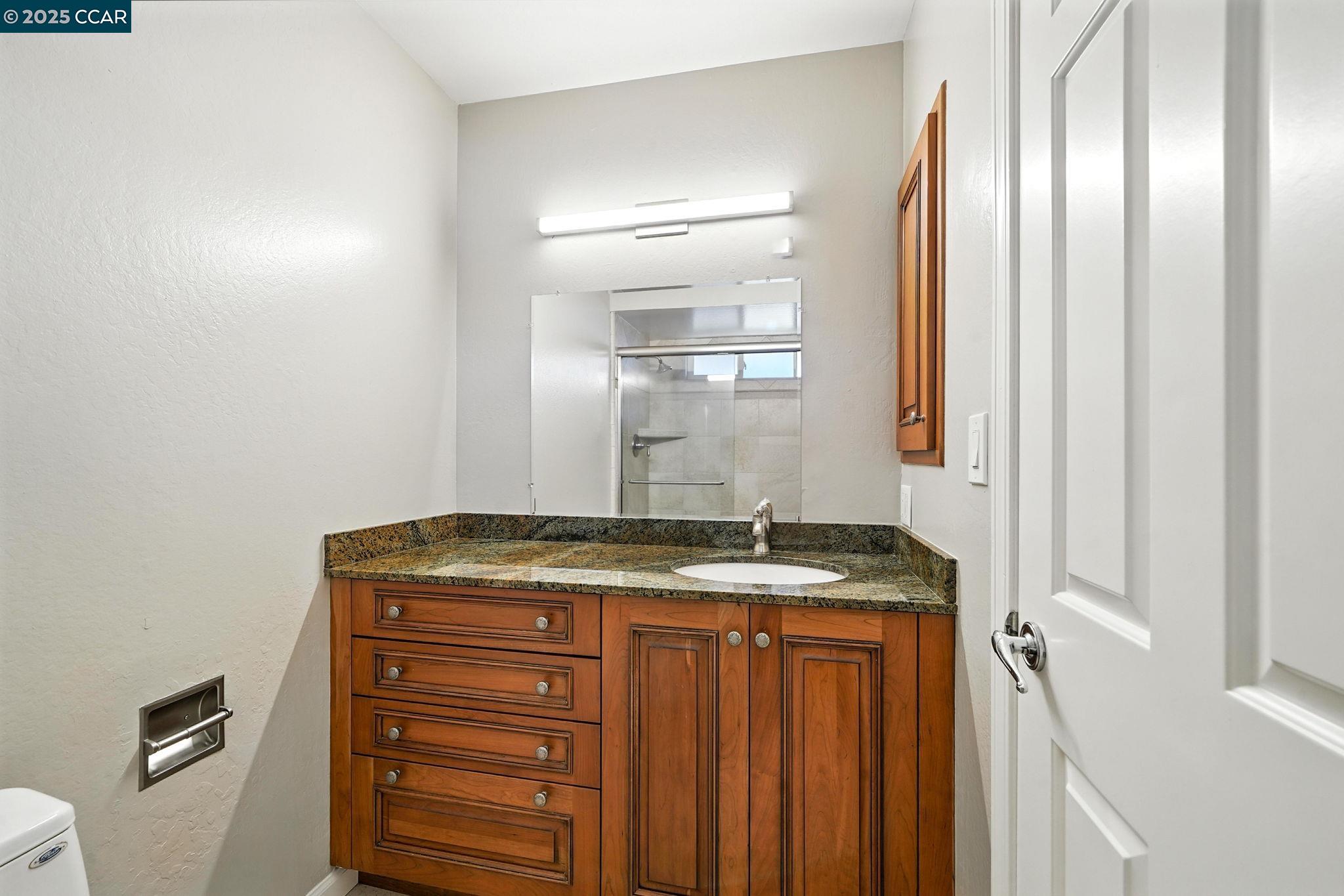 267 Duperu Drive Crockett, CA 94525 - Photo 37 of 50 a bathroom with a granite countertop sink and a mirror