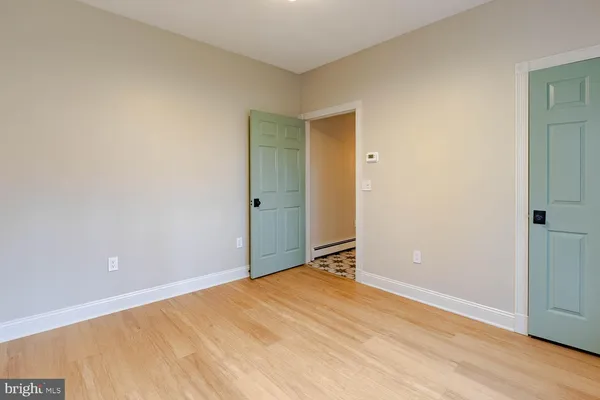 a bathroom with a glass shower door and a door