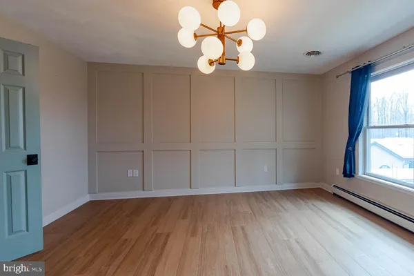 a bathroom with a granite countertop sink a toilet and mirror