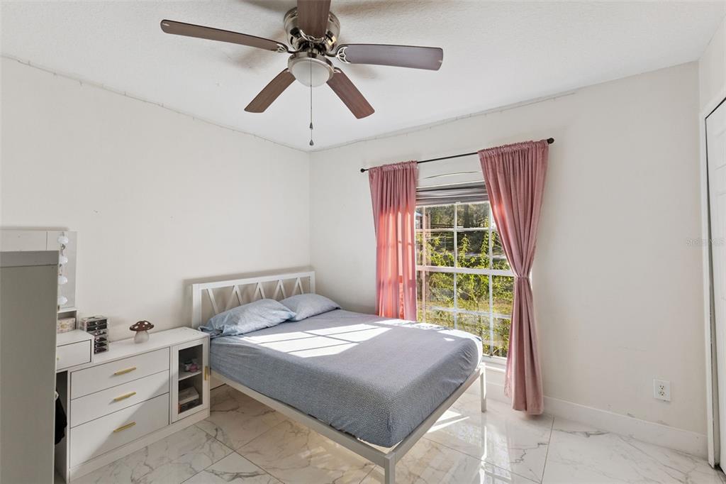 1865 15th Street Orange City, FL 32763 - Photo 11 of 21 a bedroom with a large bed and a window