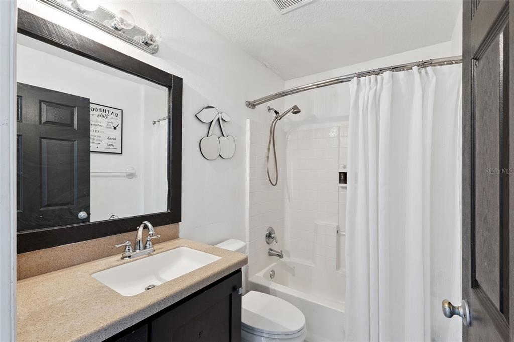 1865 15th Street Orange City, FL 32763 - Photo 13 of 21 a bathroom with a granite countertop sink toilet and shower