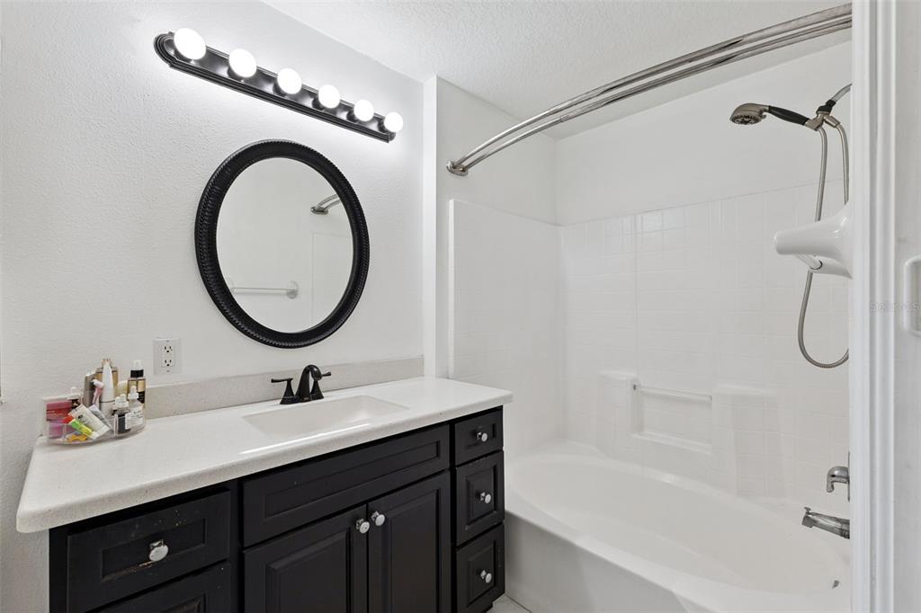 1865 15th Street Orange City, FL 32763 - Photo 15 of 21 a bathroom with a sink vanity mirror and a bathtub