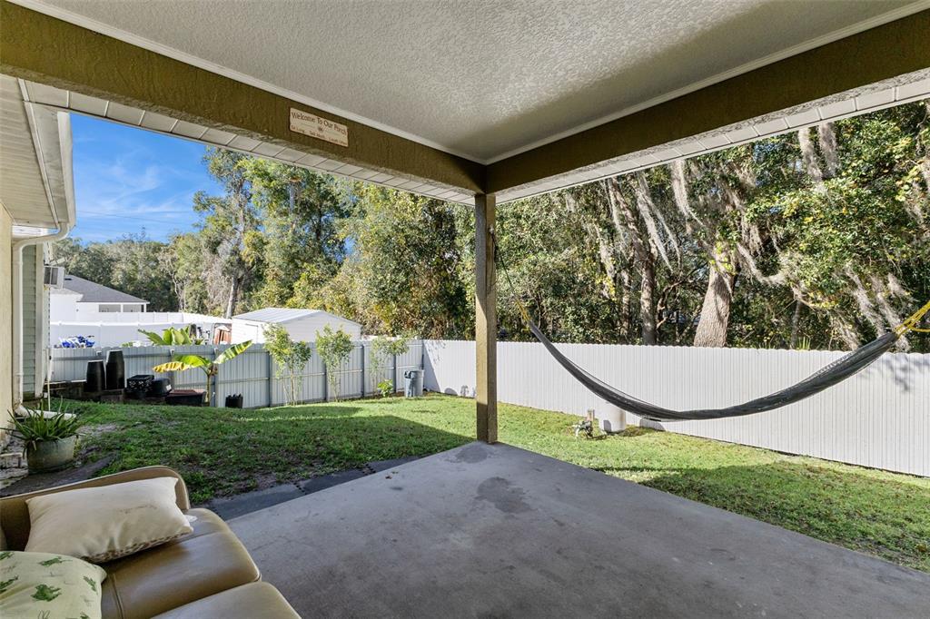 1865 15th Street Orange City, FL 32763 - Photo 19 of 21 a view of a house with a big yard potted plants and large tree