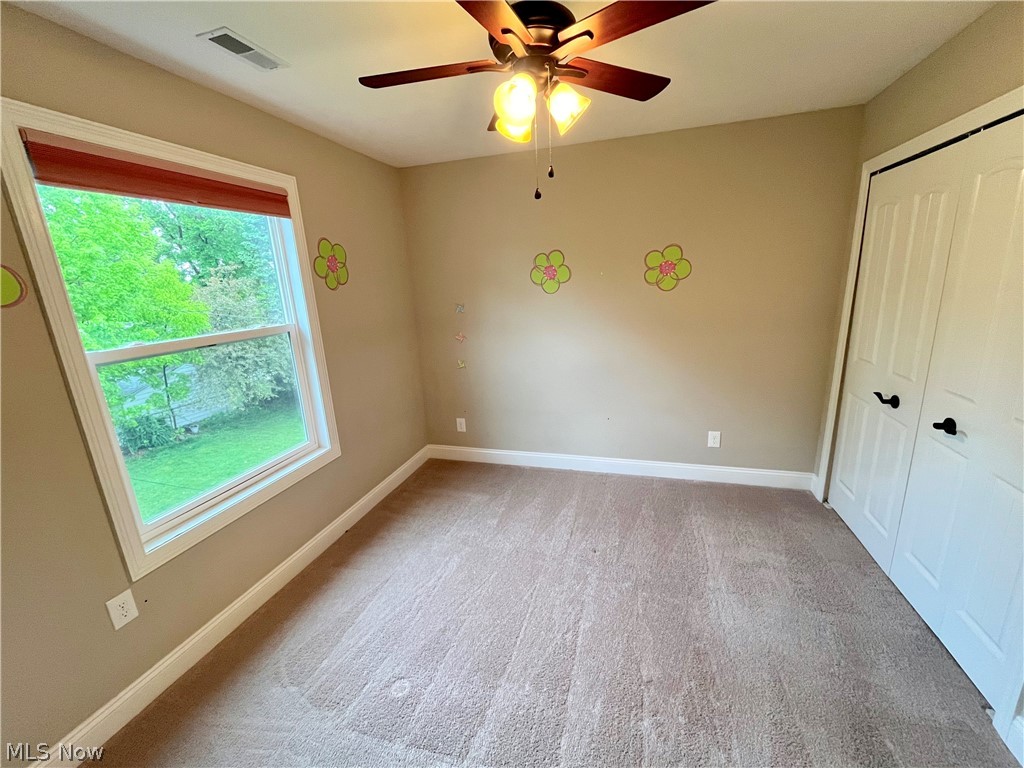 1134 Mayfield Ridge Road Cleveland, OH 44124 - Photo 29 of 41 Unfurnished bedroom featuring a closet, ceiling fan, and carpet