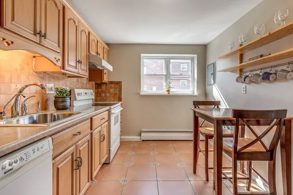 a kitchen that has a cabinets counter space and a window