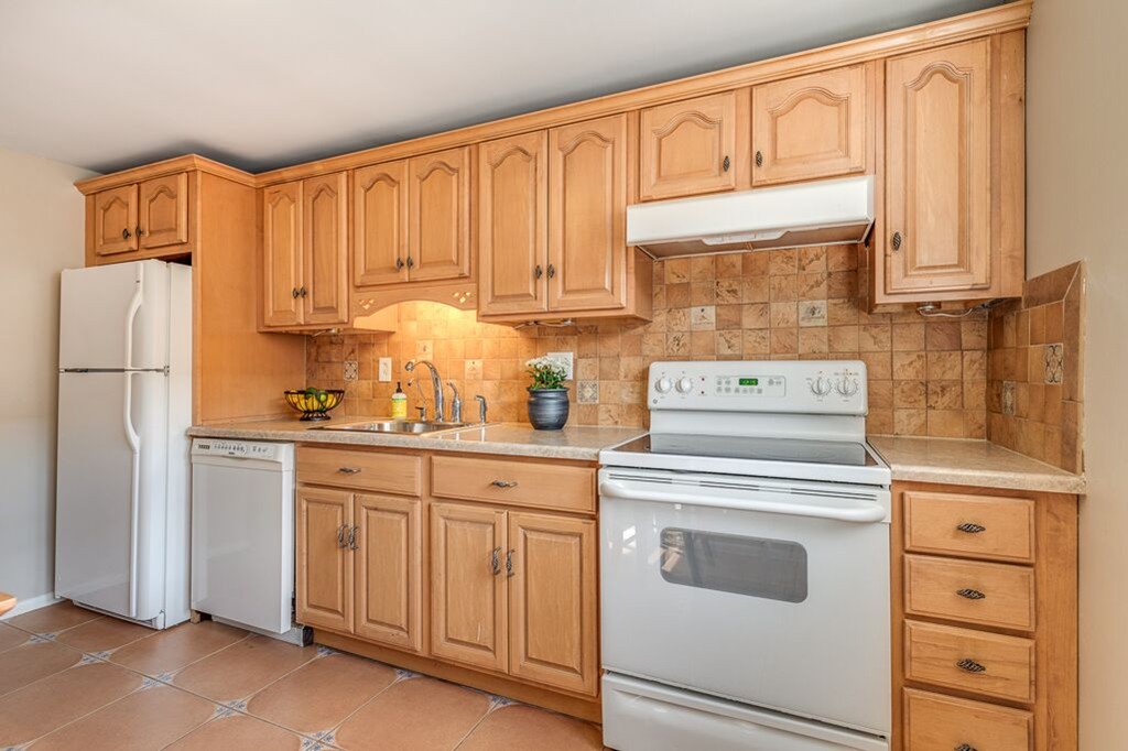 51 Colborne Road, Unit 3 Boston, MA 02135 - Photo 5 of 12 a kitchen with stainless steel appliances granite countertop a refrigerator stove and white cabinets
