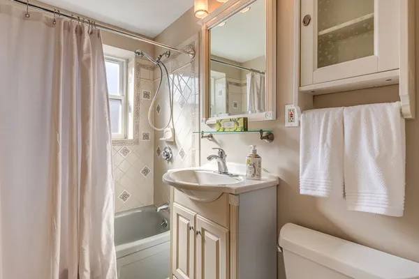 a bathroom with a sink a toilet and a mirror