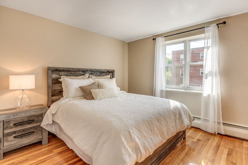 51 Colborne Road, Unit 3 Boston, MA 02135 - Photo 8 of 12 a bedroom with a bed and wooden floor