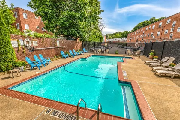a view of a swimming pool with a lounge chairs