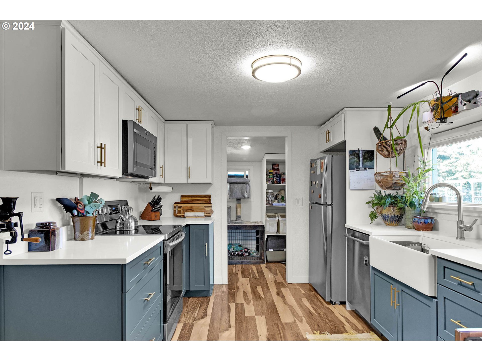 3455 Concord Street Eugene, OR 97402 - Photo 24 of 47 a kitchen with stainless steel appliances granite countertop a refrigerator a sink dishwasher and white cabinets with wooden floor