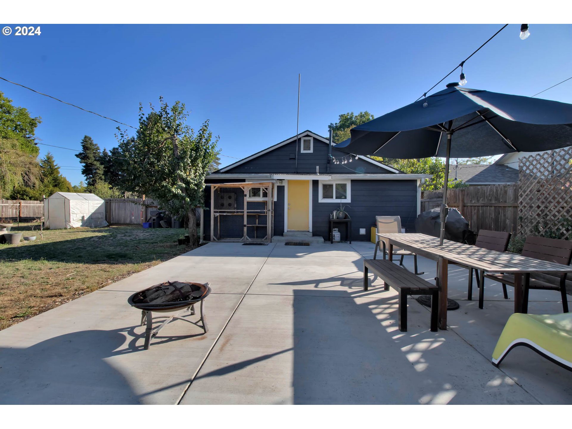 3455 Concord Street Eugene, OR 97402 - Photo 37 of 47 a patio with a table and chairs under an umbrella