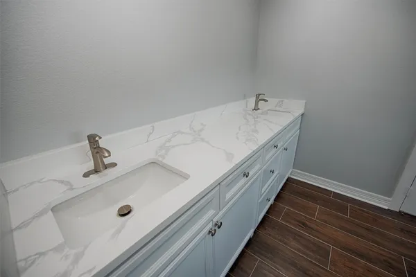 a bathroom with a double vanity sink and mirror