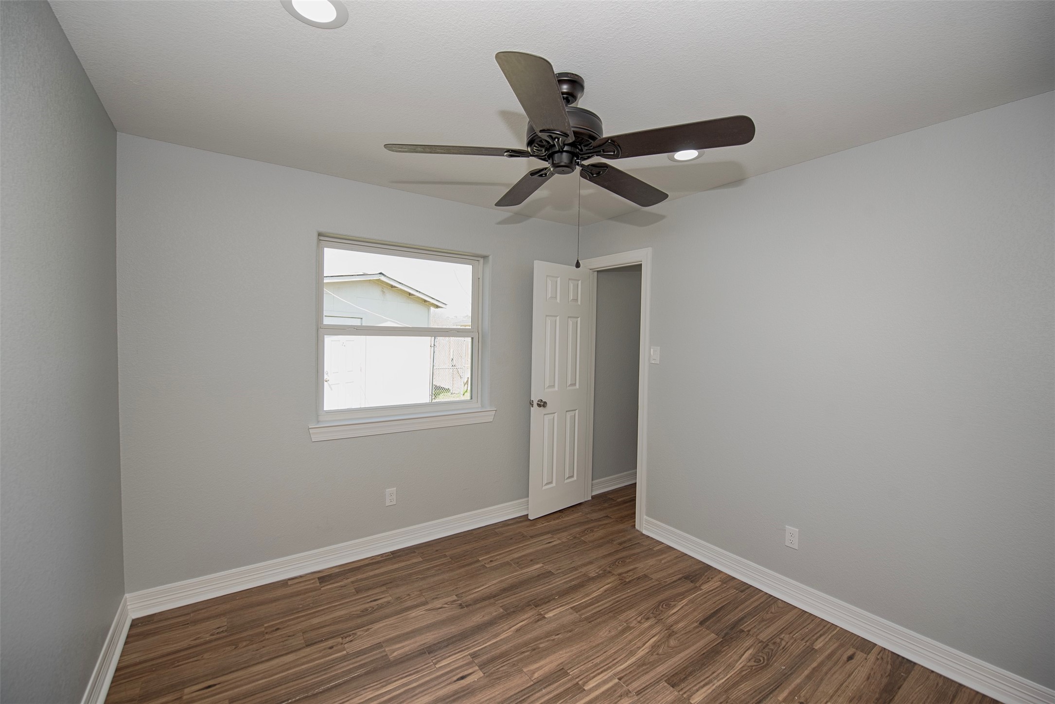 13235 Rampchester Lane Houston, TX 77015 - Photo 23 of 41 an empty room with wooden floor fan and windows