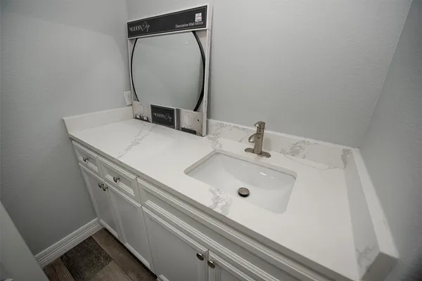 a bathroom with a sink and a mirror