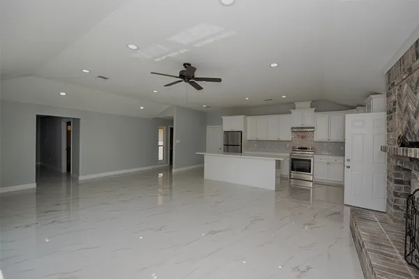 a view of kitchen with furniture and a fireplace