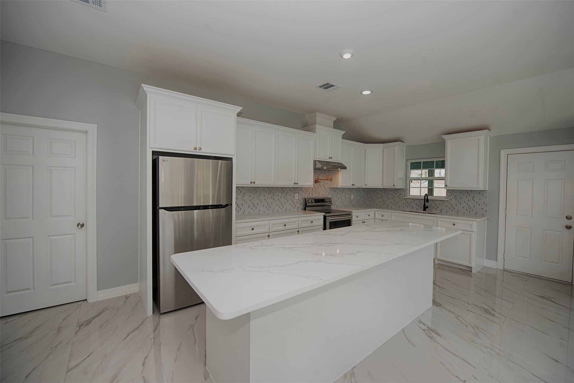 13235 Rampchester Lane Houston, TX 77015 - Photo 9 of 41 a kitchen with stainless steel appliances a sink and a refrigerator
