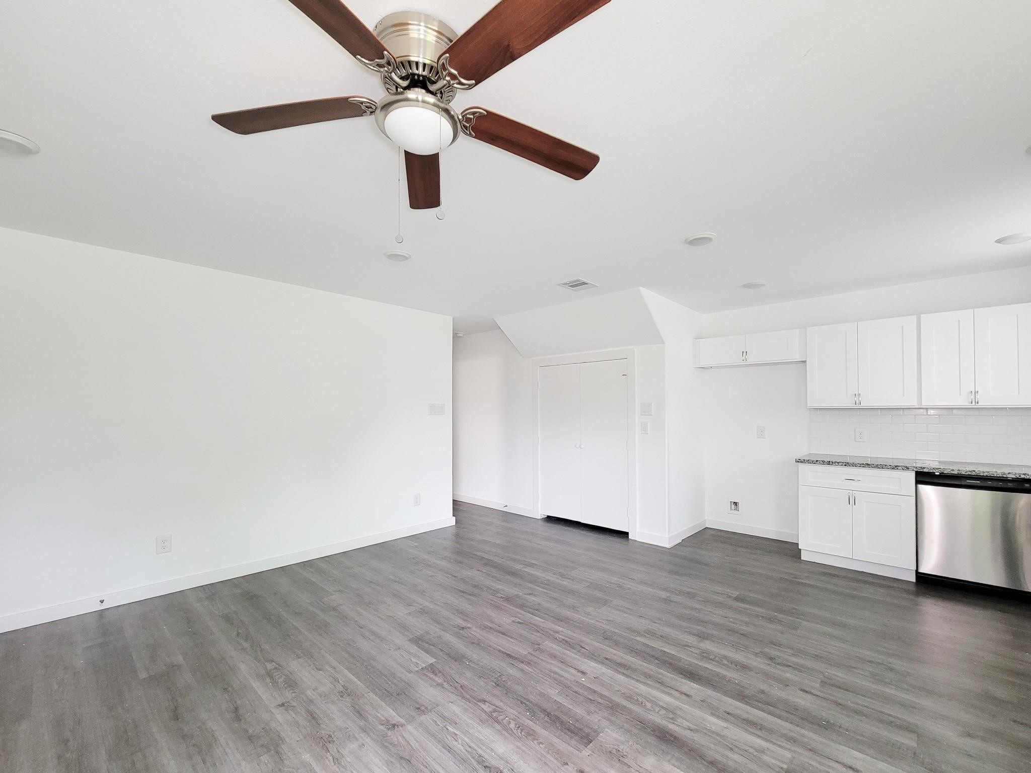 8122 Sterlingshire Street, Unit B Houston, TX 77078 - Photo 5 of 27 a view of a kitchen with a dishwasher and wooden floor