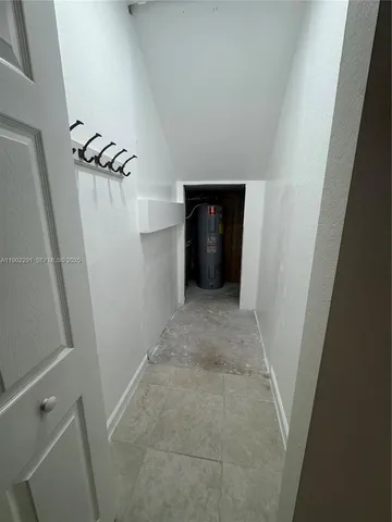 an empty room with a empty space and windows