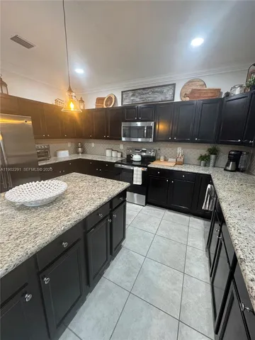 a view of a hallway to a livingroom with furniture and wooden floor
