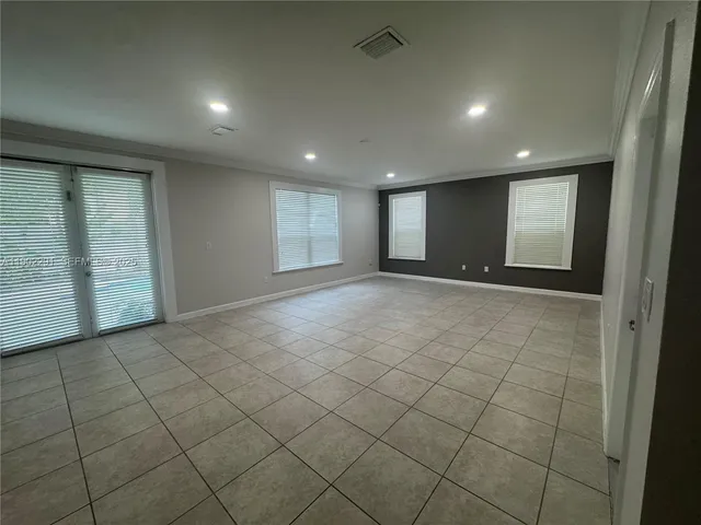 a spacious bathroom with a tub sink and mirror