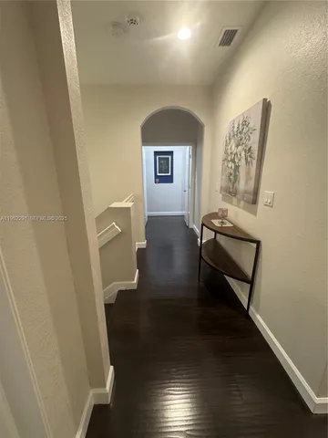 an empty room with wooden floor and closet