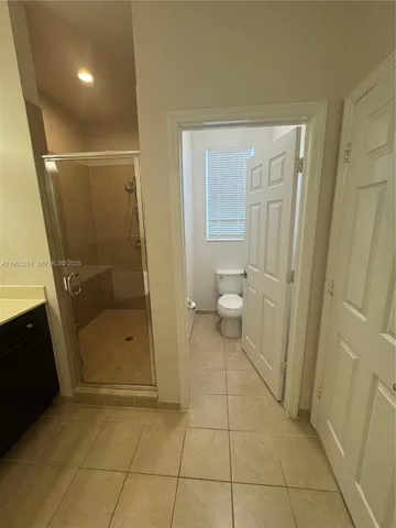 a bathroom with a sink vanity and toilet