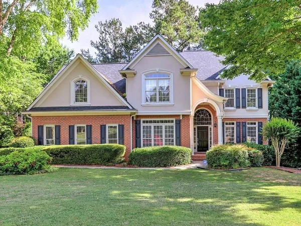 a front view of a house with a yard