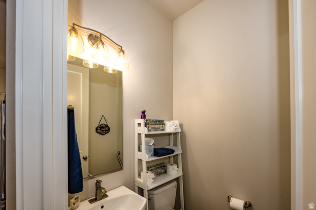 1283 North Gallen Road Santa Clara, UT 84765 - Photo 25 of 103 1/2 Bathroom with toilet and a sink off the kitchen.