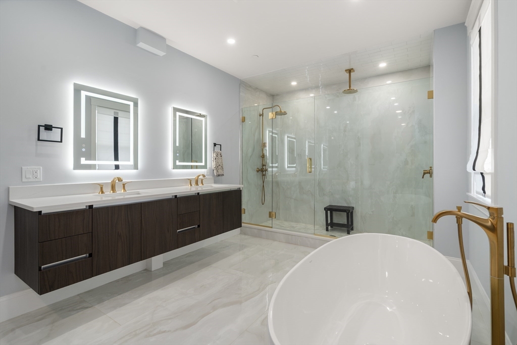 32 Pearl Street, Unit 4 Boston, MA 02125 - Photo 24 of 35 a spacious bathroom with a double vanity sink a mirror and a shower