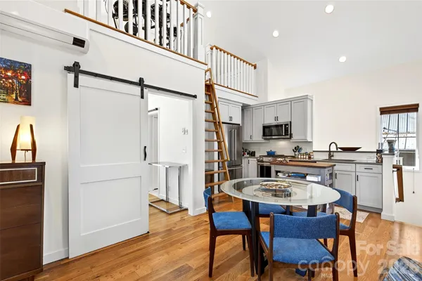 a kitchen with stainless steel appliances kitchen island granite countertop a dining table and chairs