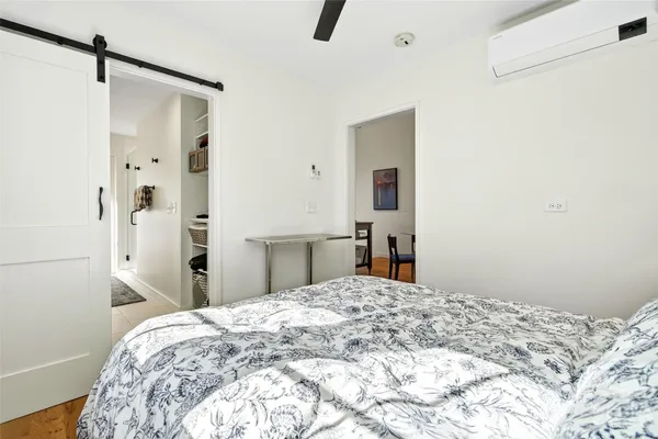 a bedroom with a bed and a dresser