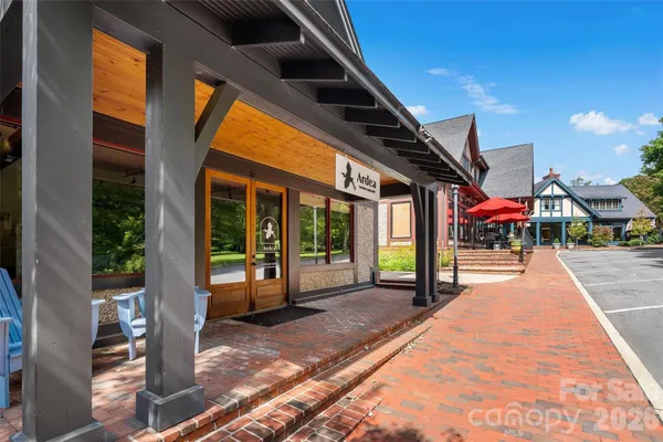 an outdoor space with seating area and trees