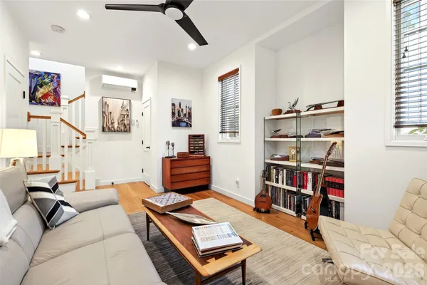 a living room with furniture cabinets and window