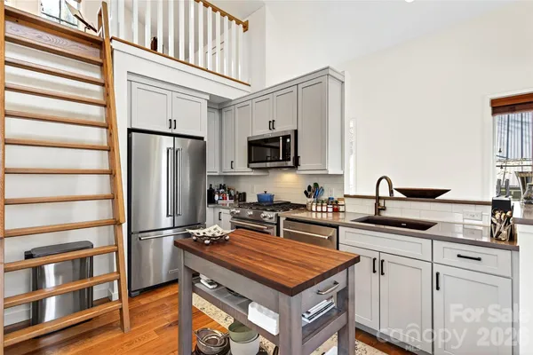 a kitchen with appliances a sink and cabinets