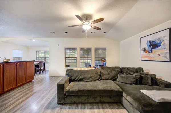 a living room with furniture a wooden floor and a window
