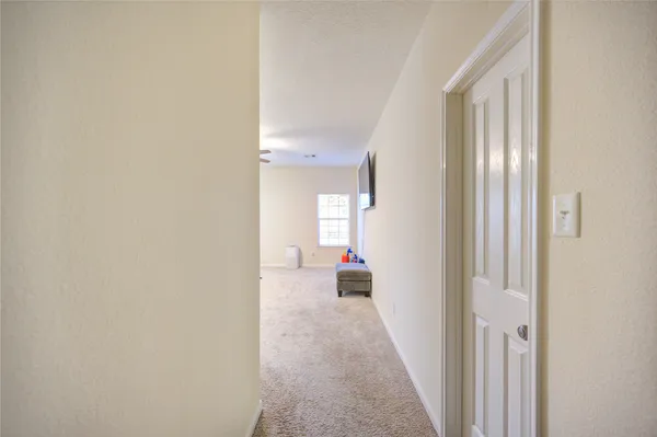 a view of a hallway with white doors