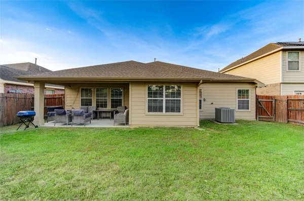 a view of a house with a backyard